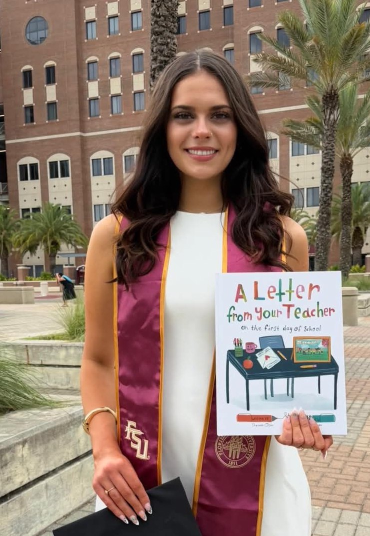 Jessica Harris at her Florida State graduation, wearing an FSU stole and holding the picture book A Letter from Your Teacher